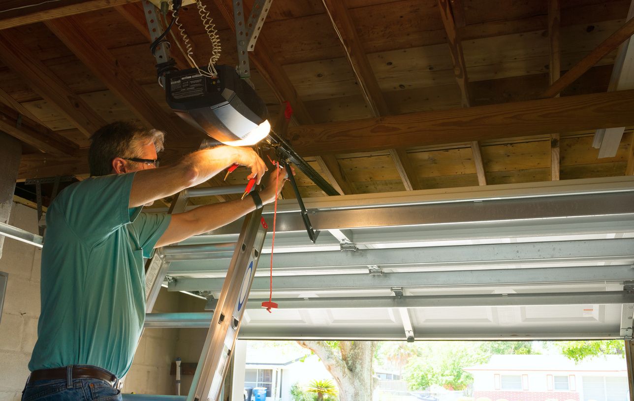 A man working on the ceiling of his garage.